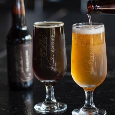 Two Monterreina craft beers served in glasses—one dark and one light—highlighting their collaboration with KOLI.